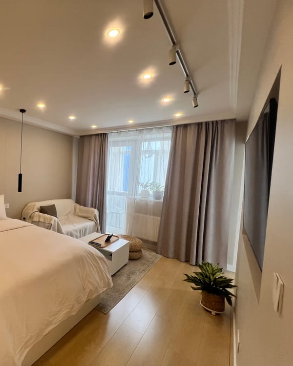 Our studio apartment: a bed, a sofa and a door to the balcony